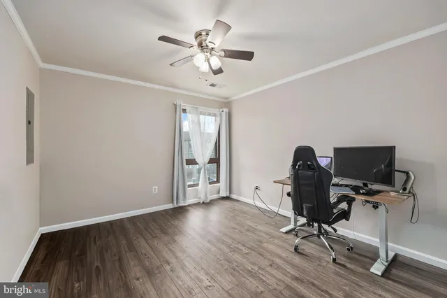 a view of workspace with wooden floor and windows