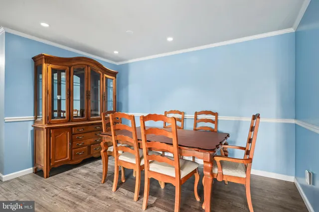 a dining room with furniture and wooden floor
