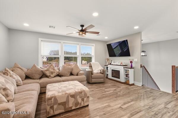 83 Whitesville Road Jackson, NJ 08527 - Photo 11 of 38 a living room with furniture a flat screen tv and a fireplace