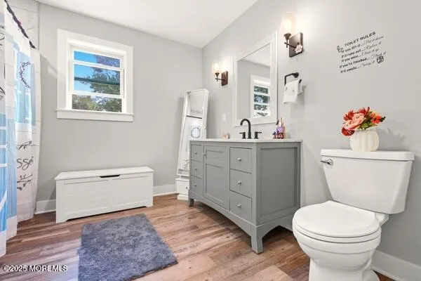 a bathroom with a toilet a sink and a mirror