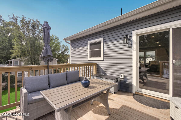 83 Whitesville Road Jackson, NJ 08527 - Photo 24 of 38 a view of a deck with couches wooden floor and fence