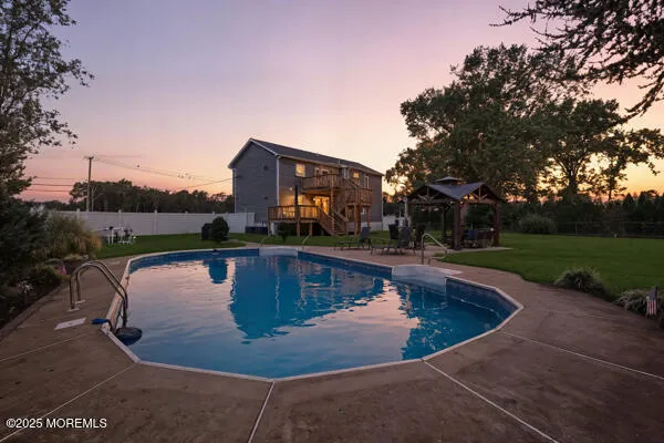 a view of swimming pool with outdoor seating and plants
