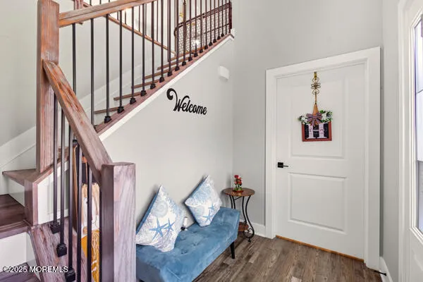 a view of a hallway with wooden floor and stairs