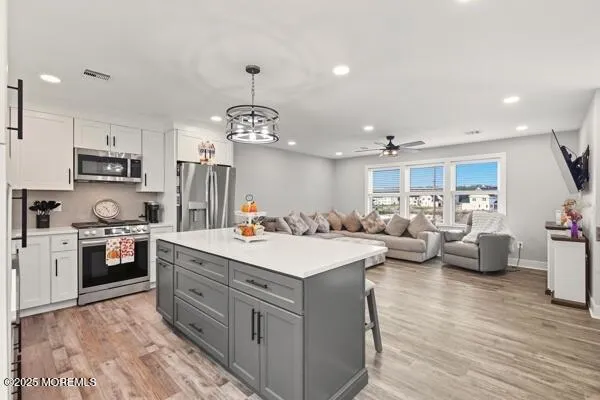 a large kitchen with kitchen island a sink a stove and a refrigerator