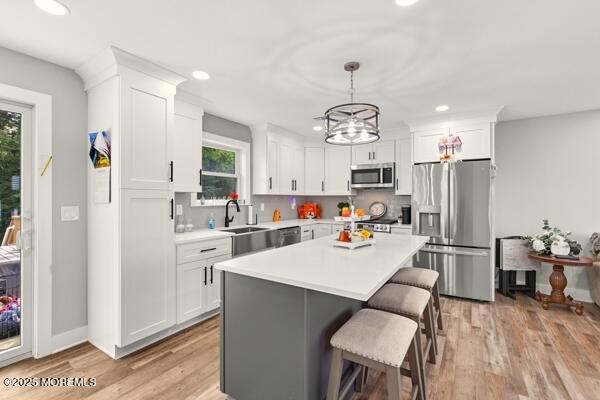 83 Whitesville Road Jackson, NJ 08527 - Photo 8 of 38 a view of a dining room and livingroom with furniture wooden floor a chandelier
