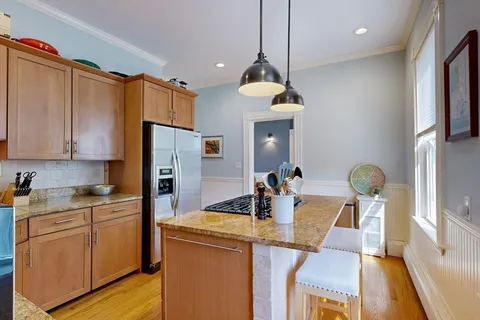 a kitchen that has a lot of cabinets a sink and appliances in it