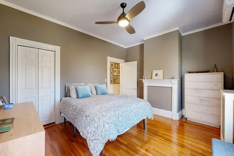 a bedroom with a bed and a dresser