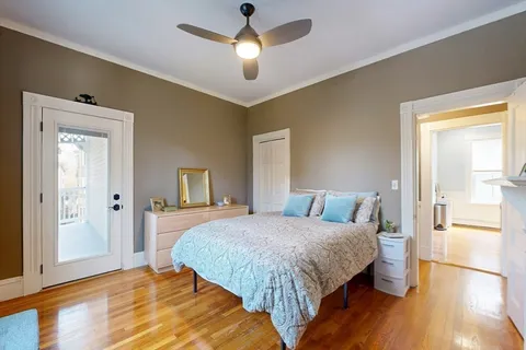 a bedroom with a bed and wooden floor