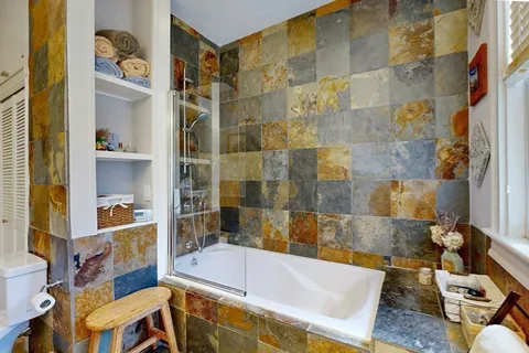 a bathroom with a tub and a shower