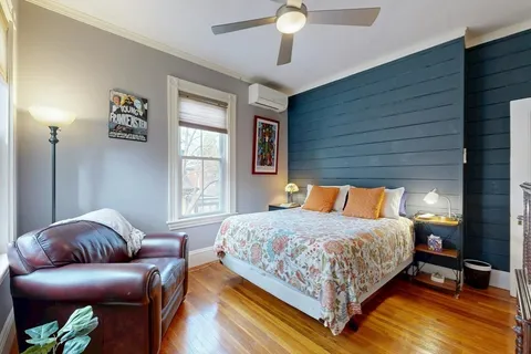 a bedroom with a bed couch and a window