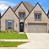 a front view of a house with a small yard and plants