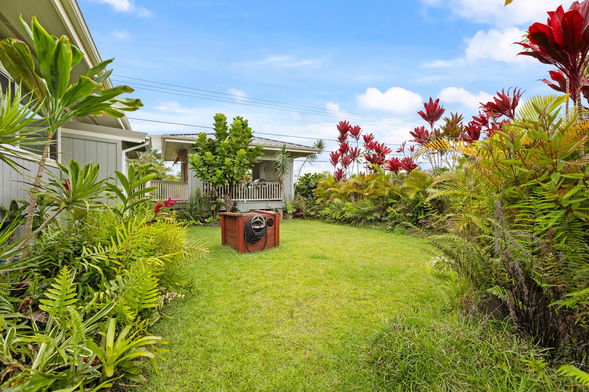 15-1635 Beach Road Keaau, HI 96749 - Photo 27 of 29 a backyard of a house with table and chairs and potted plants