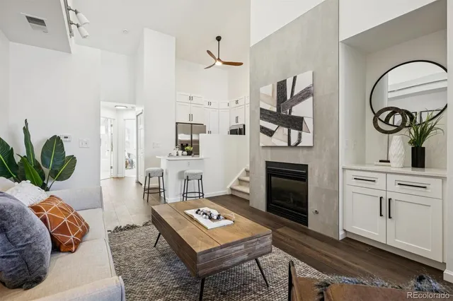 a living room with furniture a fireplace and decor