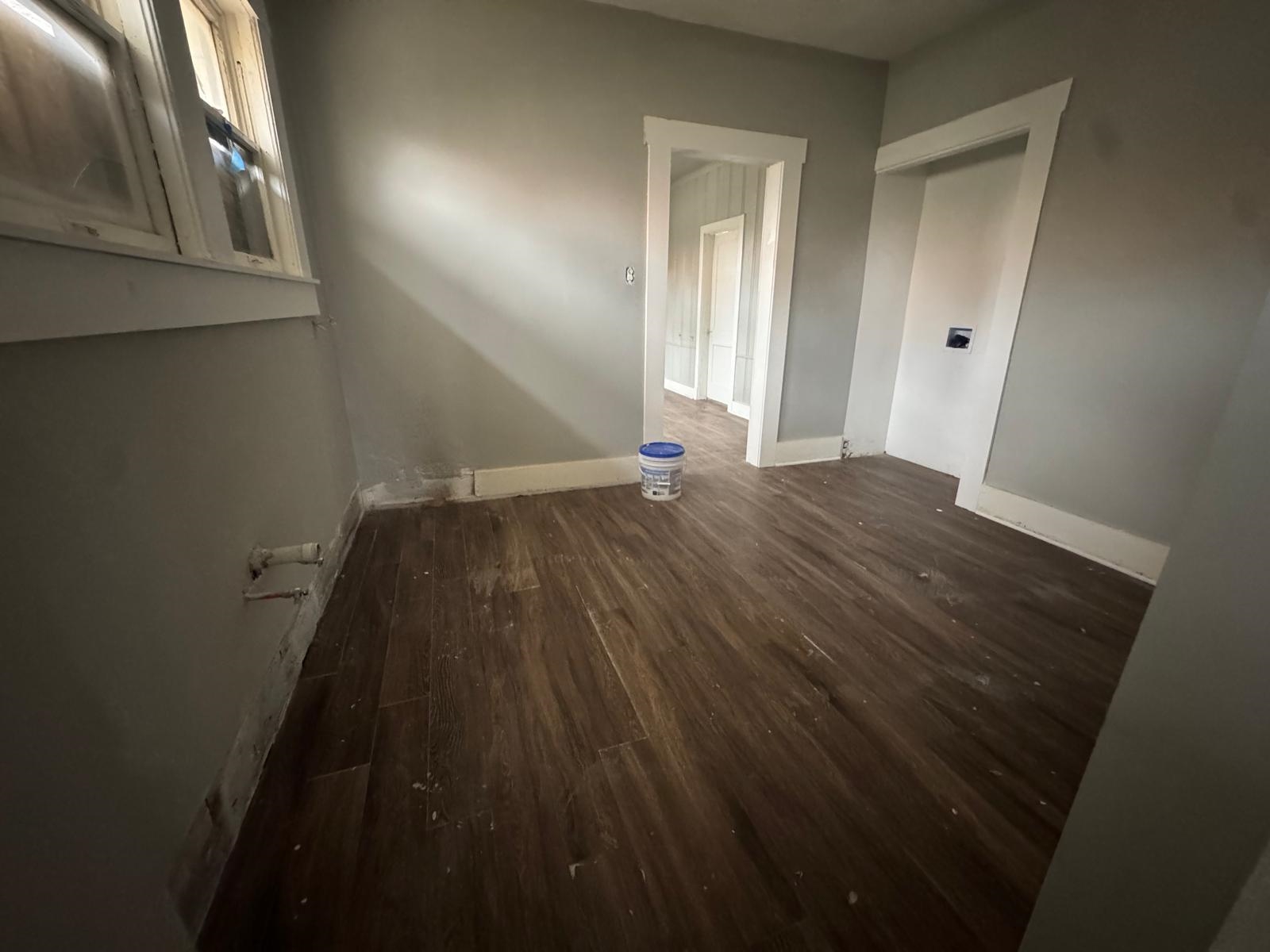 1134 Decatur Street Memphis, TN 38107 - Photo 10 of 12 a view of an empty room with wooden floor and a window