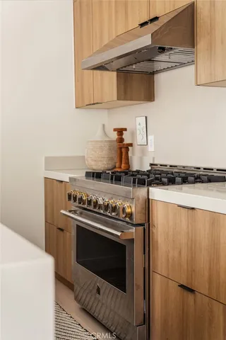 a stove top oven sitting inside of a kitchen