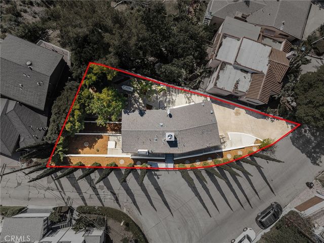 an aerial view of a house with a yard and potted plants