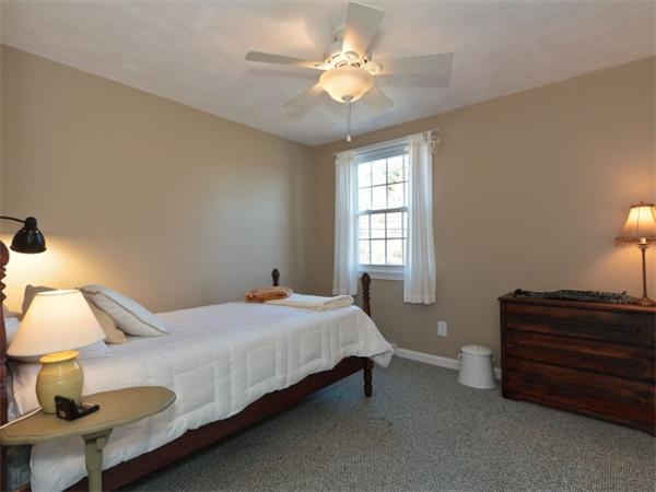 93 Allen Road Billerica, MA 01821 - Photo 18 of 25 a bedroom with a bed and a chandelier