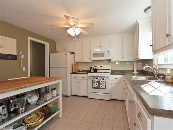 93 Allen Road Billerica, MA 01821 - Photo 3 of 25 a kitchen with a stove a sink and a refrigerator