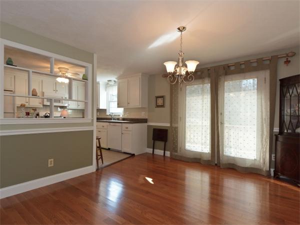 93 Allen Road Billerica, MA 01821 - Photo 5 of 25 a kitchen with stainless steel appliances granite countertop a refrigerator a sink dishwasher a stove and white cabinets with wooden floor