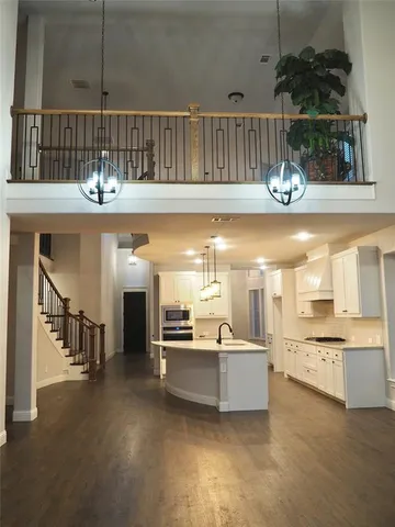 a view of a kitchen with kitchen island and stainless steel appliances