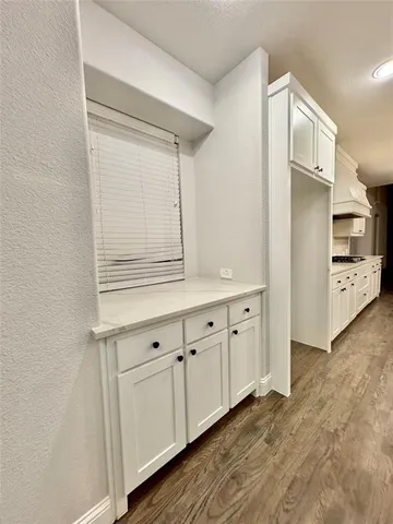 a view of cabinets and wooden floor