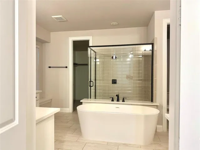 a bathroom with a bathtub and shower