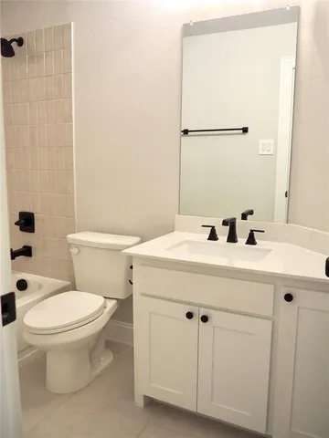 an empty room with windows and cabinet