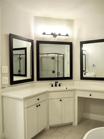 an empty room with a cabinet and a mirror