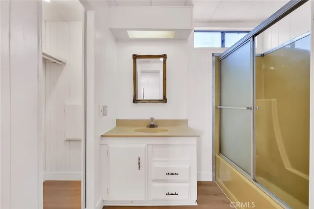 a bathroom with a glass shower door