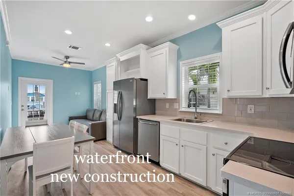a kitchen with refrigerator and cabinets