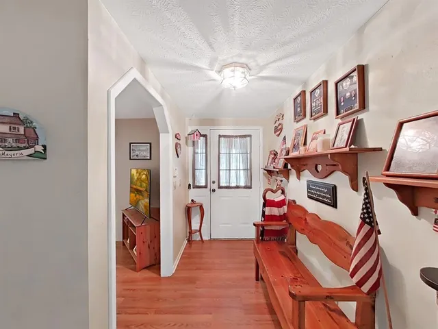 a dining room with furniture a window and wooden floor