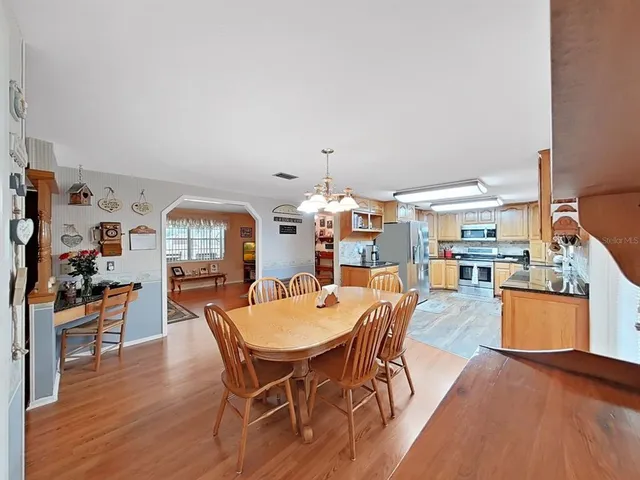 a view of a dining room with furniture and chandelier