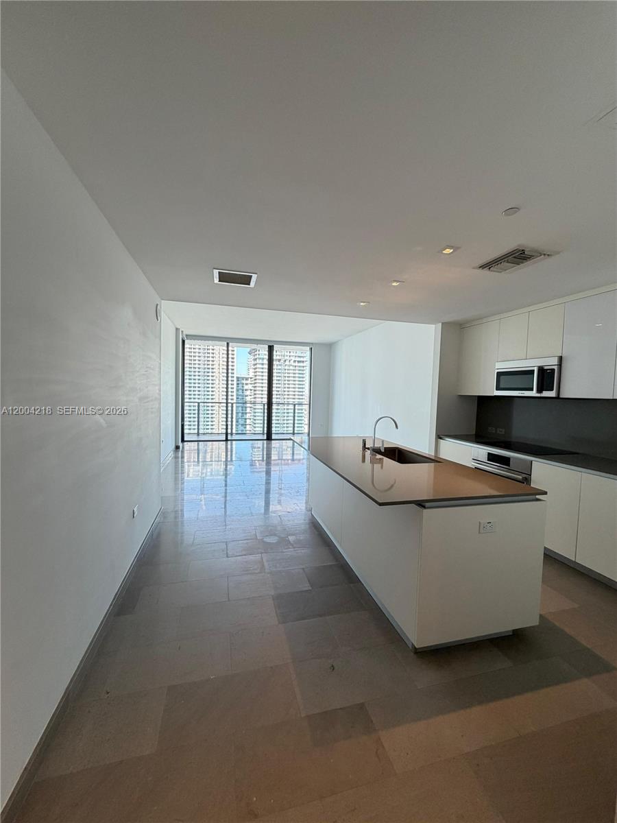 68 Southeast 6th Street, Unit 2506 Miami, FL 33131 - Photo 1 of 16 a living room with furniture and a large window