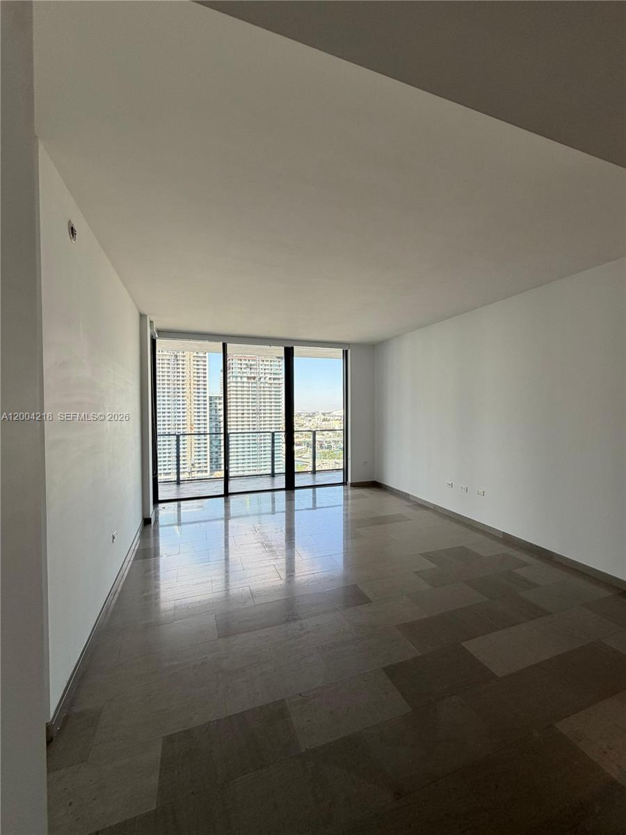 68 Southeast 6th Street, Unit 2506 Miami, FL 33131 - Photo 4 of 16 a view of an empty room with a window