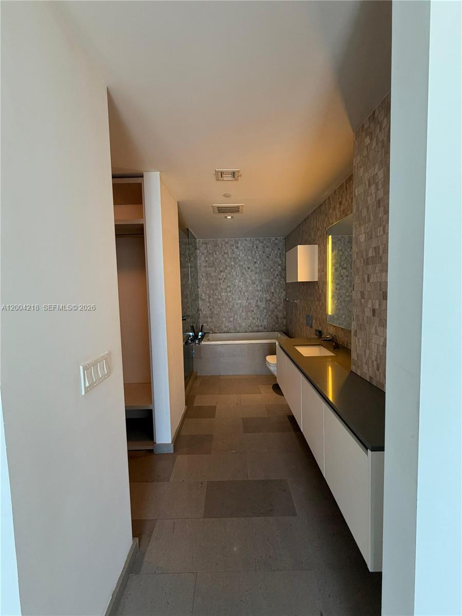 68 Southeast 6th Street, Unit 2506 Miami, FL 33131 - Photo 6 of 16 a view of a hallway with a large window