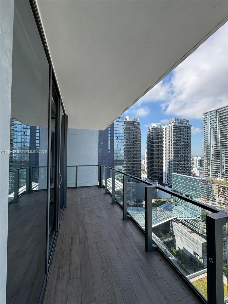 68 Southeast 6th Street, Unit 2506 Miami, FL 33131 - Photo 10 of 16 a room with lots of counter space and wooden floor