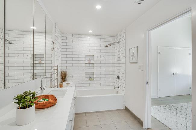 908 Holly Road Belmont, CA 94002 - Photo 23 of 50 a bathroom with a tub sink and shower