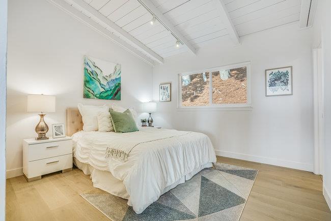 908 Holly Road Belmont, CA 94002 - Photo 24 of 50 a bedroom with a bed and a painting on the wall