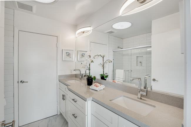 908 Holly Road Belmont, CA 94002 - Photo 27 of 50 a bathroom with double vanity sink and a mirror