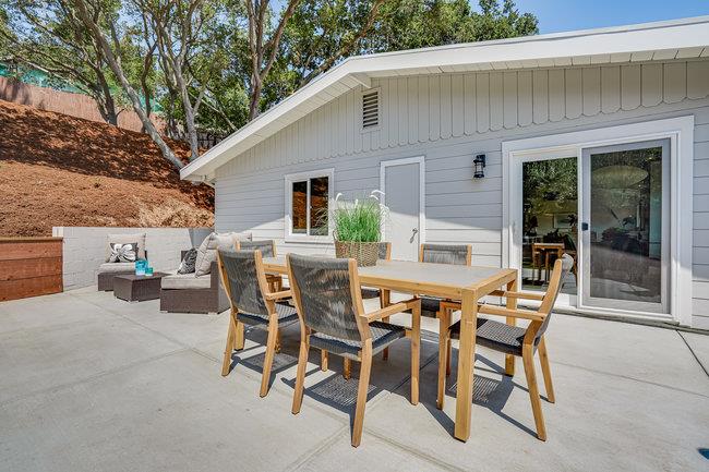 908 Holly Road Belmont, CA 94002 - Photo 30 of 50 a view of a patio with table and chairs and potted plants