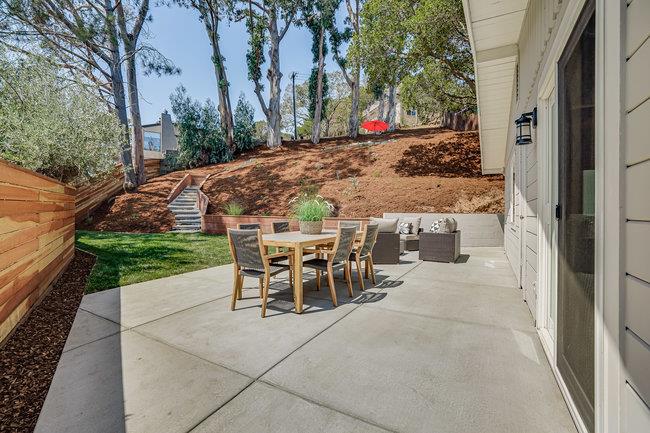 908 Holly Road Belmont, CA 94002 - Photo 32 of 50 a view of a patio with table and chairs and potted plants