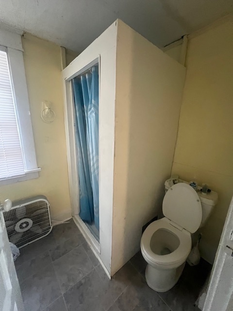 312 North 5th Avenue Kankakee, IL 60901 - Photo 15 of 22 a bathroom with a sink a toilet and a mirror