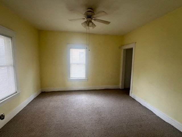 312 North 5th Avenue Kankakee, IL 60901 - Photo 9 of 22 an empty room with a window and a ceiling fan