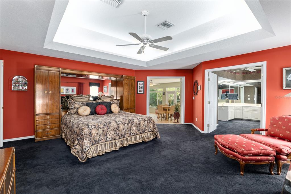 2215 Spring Hill Court Ocala, FL 34471 - Photo 26 of 62 a living room with furniture a flat screen tv and a chandelier