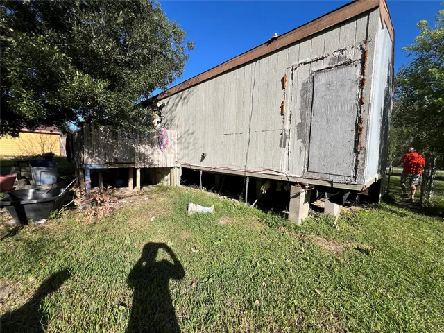 a view of a backyard with a table and chairs