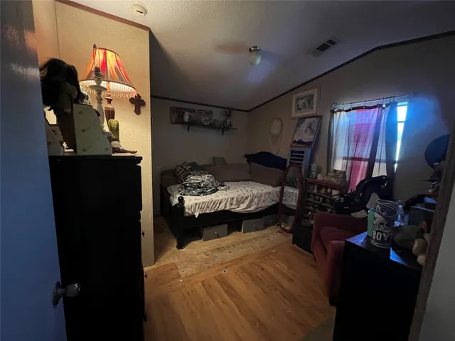 a bedroom with bed and window