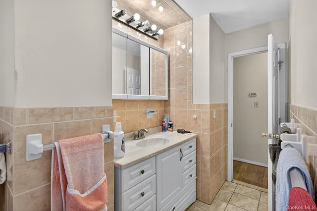 a bathroom with a sink a vanity and a mirror