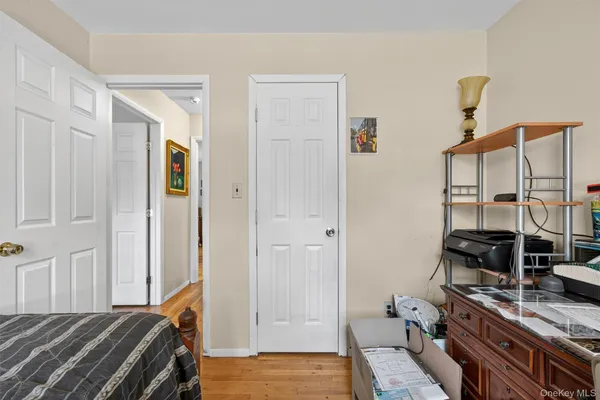 a bedroom with a bed and a flat tv screen on the dresser