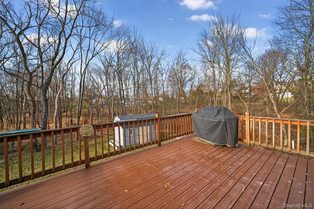 a view of a balcony with wooden floor and fence