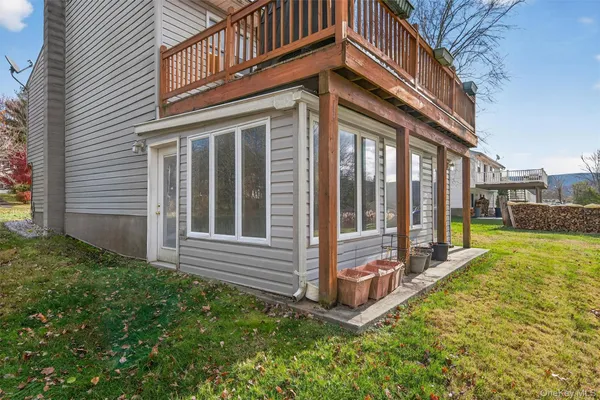 a view of a house with a large window and a yard